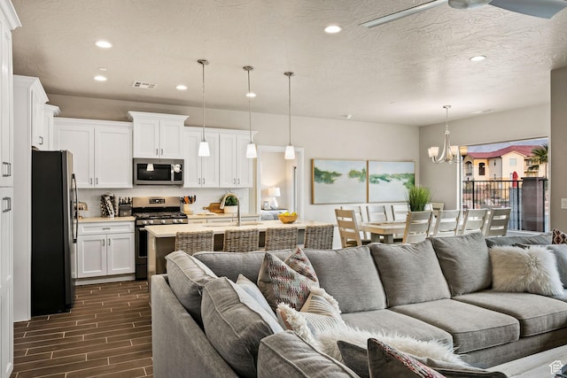 259 N 2020 W, Hurricane, UT 84737 - living room with recessed lighting, a chandelier, and dark wood-type flooring