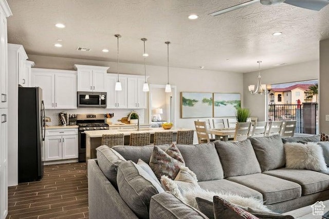259 N 2020 W, Hurricane, UT 84737 - living room with recessed lighting, wood tiled floors, and a chandelier