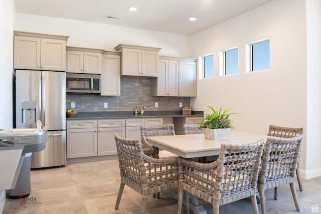 259 N 2020 W, Hurricane, UT 84737 - kitchen featuring stainless steel appliances, decorative backsplash, recessed lighting, gray cabinetry, and dark countertops