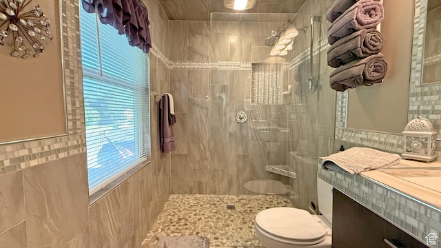 11766 S Hidden Valley Rd E, Sandy, UT 84092 - bathroom featuring tile walls, a tile shower, and vanity