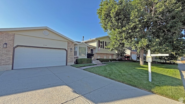 11766 S Hidden Valley Rd E, Sandy, UT 84092 - split level home with brick siding, concrete driveway, a front lawn, and a garage