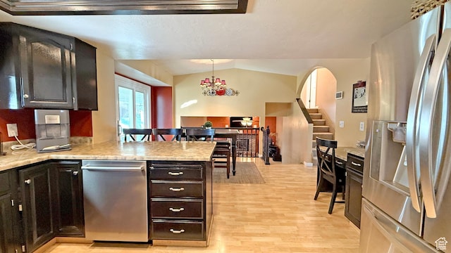 11766 S Hidden Valley Rd E, Sandy, UT 84092 - kitchen with appliances with stainless steel finishes, light wood finished floors, a peninsula, light countertops, and lofted ceiling