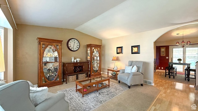 11766 S Hidden Valley Rd E, Sandy, UT 84092 - living room with arched walkways, lofted ceiling, and light wood finished floors