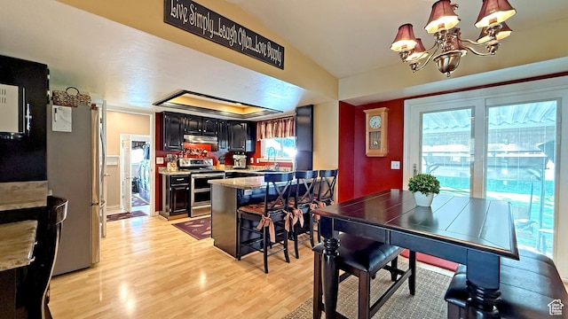 11766 S Hidden Valley Rd E, Sandy, UT 84092 - dining space featuring light wood finished floors, a chandelier, and lofted ceiling