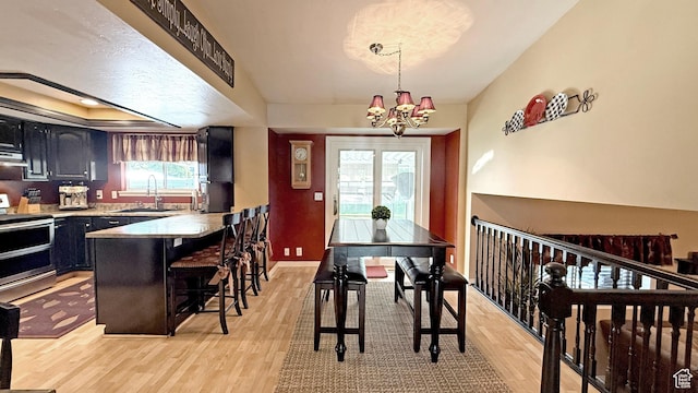 11766 S Hidden Valley Rd E, Sandy, UT 84092 - dining space with light wood-style floors and a chandelier