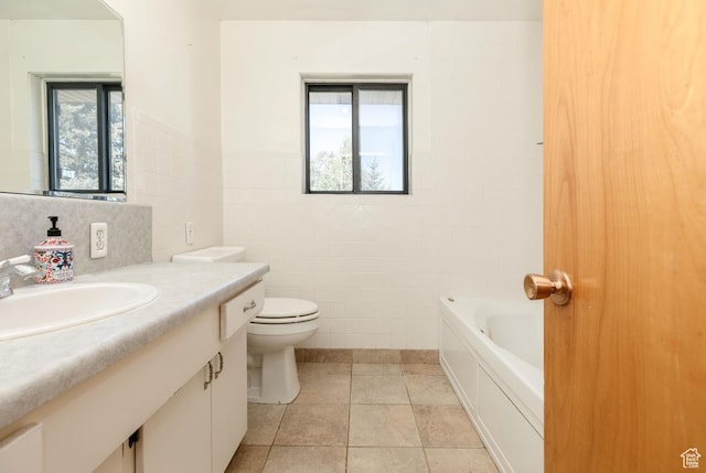 869 N 1600 E, Preston, ID 83263 - bathroom with tile walls, vanity, a tub, tile patterned floors, and wainscoting