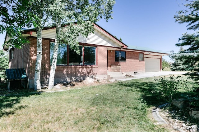 869 N 1600 E, Preston, ID 83263 - ranch-style home featuring a garage, brick siding, a front lawn, and concrete driveway