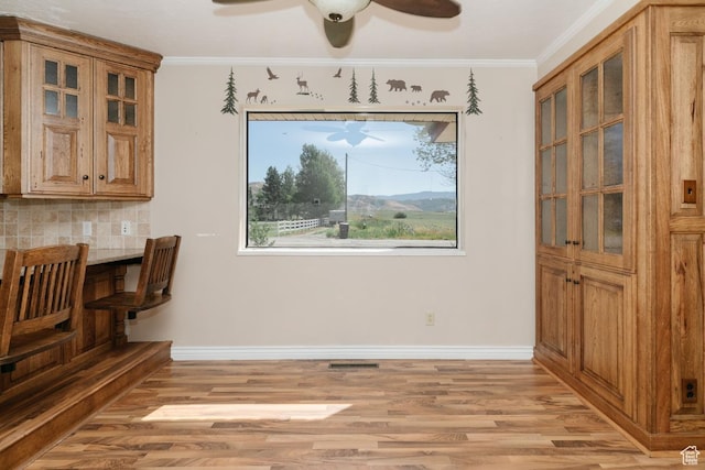 869 N 1600 E, Preston, ID 83263 - unfurnished dining area featuring ceiling fan, light wood finished floors, and ornamental molding