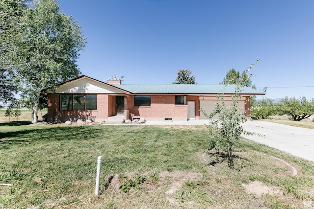 869 N 1600 E, Preston, ID 83263 - single story home with concrete driveway, brick siding, a front lawn, and a garage