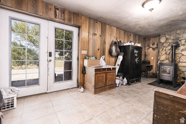 440 N Quarry Rd, Salina, UT 84654 - doorway with wooden walls, a wood stove, and light tile patterned floors