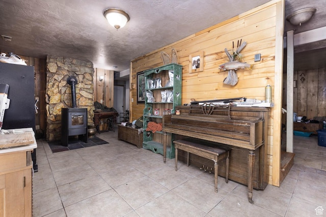 440 N Quarry Rd, Salina, UT 84654 - miscellaneous room featuring wooden walls, a wood stove, and light tile patterned floors
