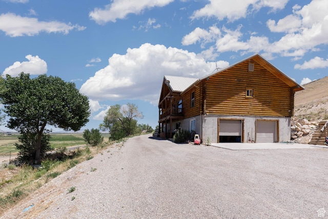 440 N Quarry Rd, Salina, UT 84654 - view of property exterior with log siding, an attached garage, driveway, and a metal roof