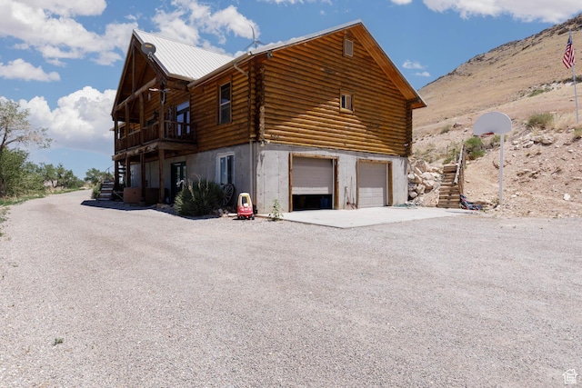 440 N Quarry Rd, Salina, UT 84654 - view of side of home featuring log siding, an attached garage, gravel driveway, and a mountain view