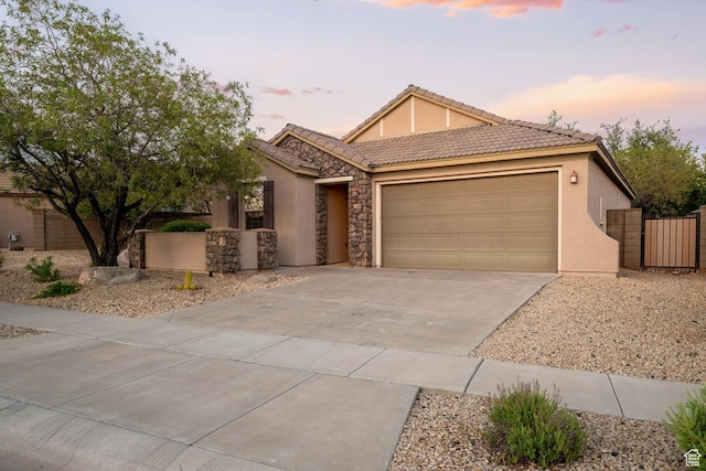 1200 N Crown King Ave, Washington, UT 84780 - single story home featuring an attached garage, driveway, a gate, stucco siding, and a tile roof