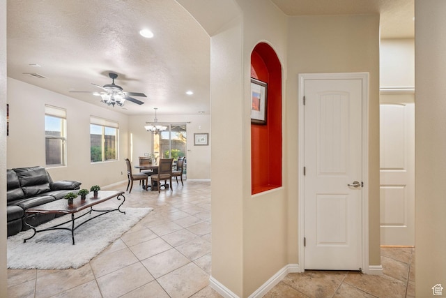 1200 N Crown King Ave, Washington, UT 84780 - hall featuring arched walkways, light tile patterned floors, a chandelier, and recessed lighting