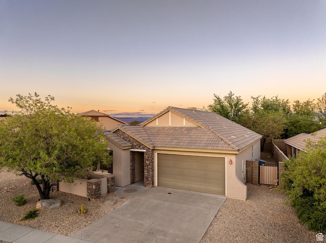 1200 N Crown King Ave, Washington, UT 84780 - view of front of property with a garage, stucco siding, concrete driveway, a tiled roof, and a gate