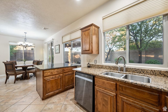 1200 N Crown King Ave, Washington, UT 84780 - kitchen featuring dishwasher, brown cabinets, healthy amount of natural light, dark stone countertops, and a textured ceiling