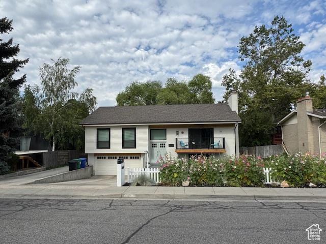 4650 S Chapel Dr E, Salt Lake City, UT 84117 - view of front of property with an attached garage, driveway, and a chimney