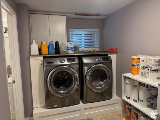 4650 S Chapel Dr E, Salt Lake City, UT 84117 - washroom with washer and dryer, light tile patterned floors, and cabinet space