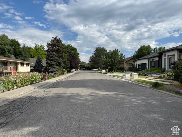 4650 S Chapel Dr E, Salt Lake City, UT 84117 - view of asphalt street with sidewalks, a residential view, and curbs
