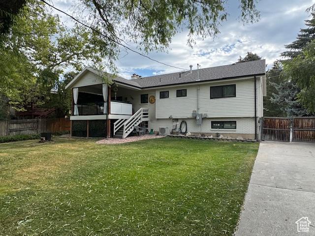 4650 S Chapel Dr E, Salt Lake City, UT 84117 - rear view of house featuring stairway and driveway