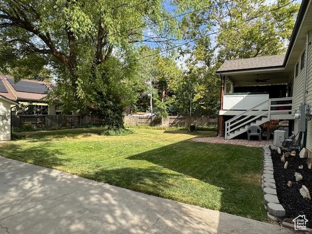 4650 S Chapel Dr E, Salt Lake City, UT 84117 - view of yard featuring a ceiling fan, stairway, and a patio area