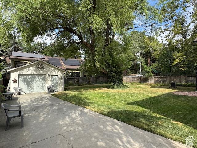 4650 S Chapel Dr E, Salt Lake City, UT 84117 - view of yard with concrete driveway, a garage, and an outbuilding