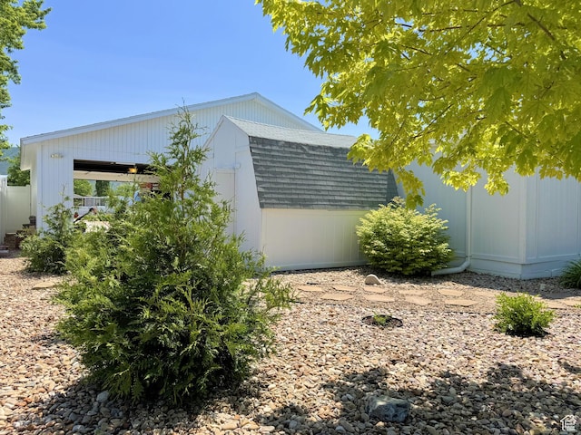804 Fleetwood Dr, Tooele, UT 84074 - view of side of property with a shingled roof and a shed