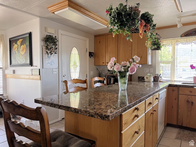 804 Fleetwood Dr, Tooele, UT 84074 - kitchen featuring light tile patterned floors, dishwasher, healthy amount of natural light, and brown cabinets