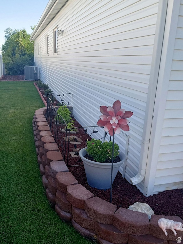 804 Fleetwood Dr, Tooele, UT 84074 - view of side of home featuring a central AC unit and a lawn
