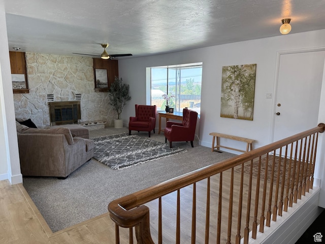 262 N 400 E, Fairview, UT 84629 - living area featuring wood finished floors, a ceiling fan, and a stone fireplace