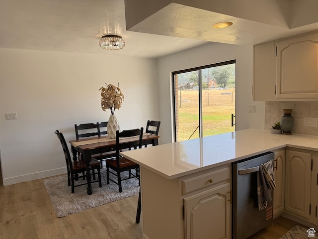262 N 400 E, Fairview, UT 84629 - kitchen with dishwasher, a peninsula, light wood-type flooring, light countertops, and decorative backsplash