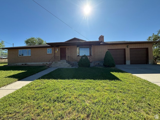 262 N 400 E, Fairview, UT 84629 - ranch-style house featuring brick siding, a front lawn, an attached garage, driveway, and a chimney