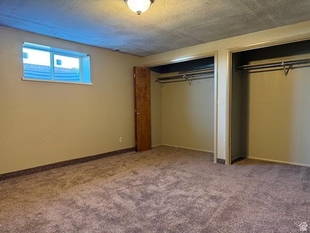 262 N 400 E, Fairview, UT 84629 - unfurnished bedroom with multiple closets, carpet, and a textured ceiling