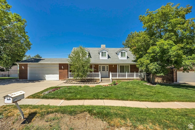 1936 S 800 E, Bountiful, UT 84010 - new england style home featuring driveway, brick siding, a garage, covered porch, and a front lawn
