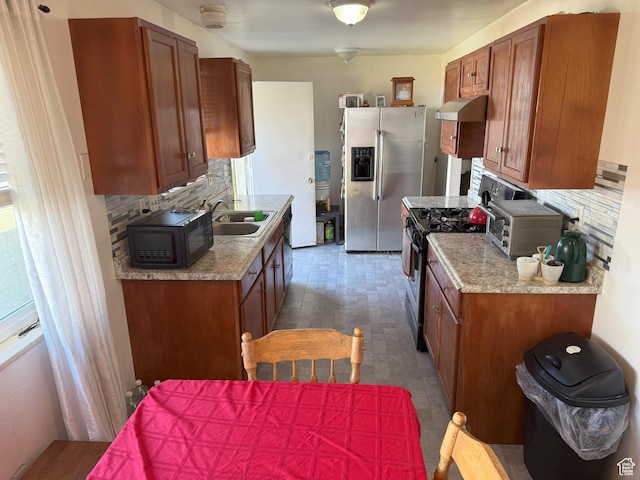 1344 N 280 W, Pleasant Grove, UT 84062 - kitchen with stainless steel appliances, under cabinet range hood, light countertops, brown cabinets, and decorative backsplash