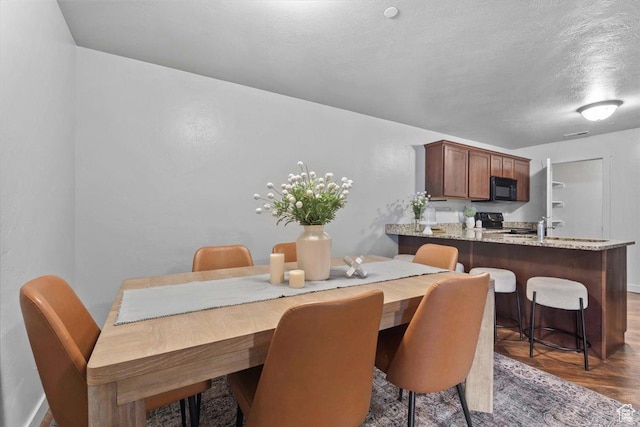 491 S Freedom Blvd Unit 104204, Provo, UT 84601 - dining area with wood finished floors and a textured ceiling