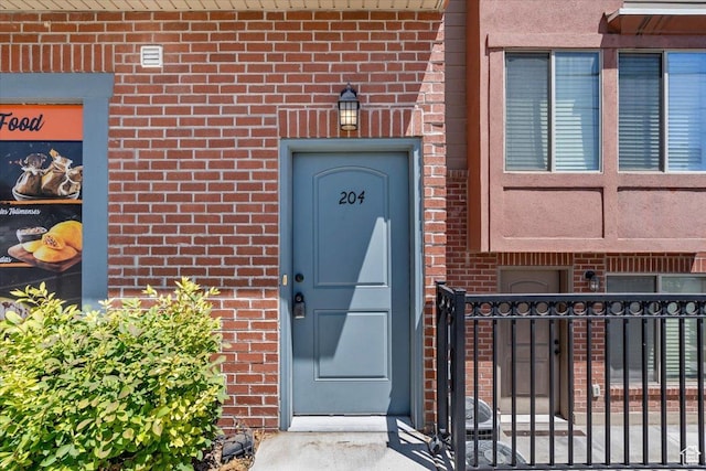 491 S Freedom Blvd Unit 104204, Provo, UT 84601 - view of exterior entry with brick siding and a gate