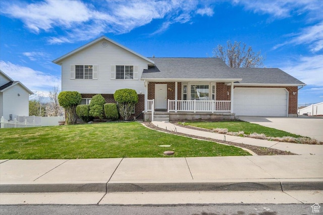 971 N 600 E, Springville, UT 84663 - split level home with brick siding, a porch, concrete driveway, and an attached garage