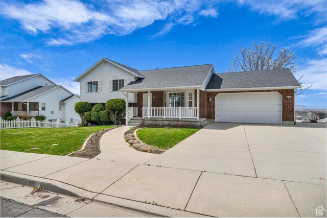 971 N 600 E, Springville, UT 84663 - split level home with covered porch, brick siding, driveway, a garage, and a shingled roof