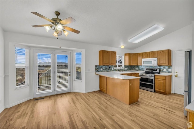 971 N 600 E, Springville, UT 84663 - kitchen featuring appliances with stainless steel finishes, a peninsula, a ceiling fan, light countertops, and vaulted ceiling