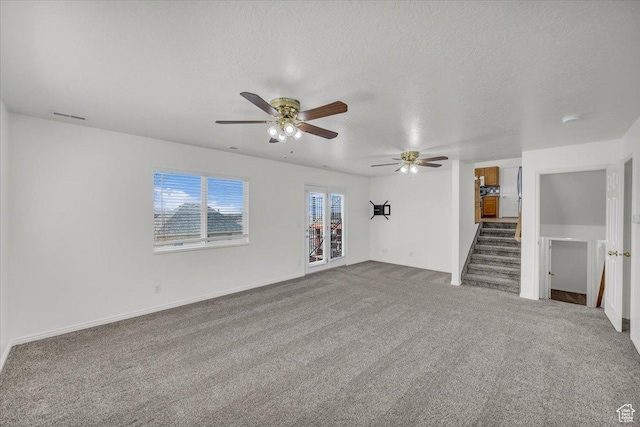 971 N 600 E, Springville, UT 84663 - unfurnished living room with a ceiling fan, healthy amount of natural light, carpet flooring, and a textured ceiling