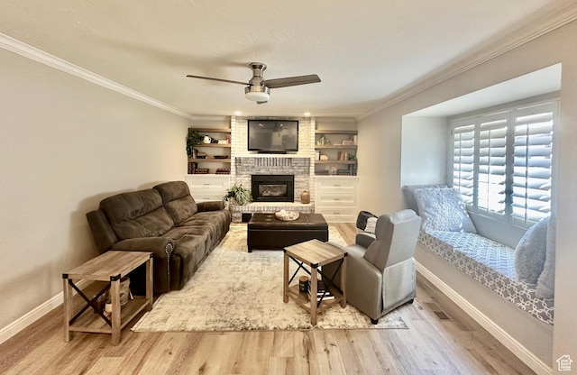 2442 N 2275 E, Layton, UT 84040 - living area with wood finished floors, ceiling fan, crown molding, a fireplace, and built in features