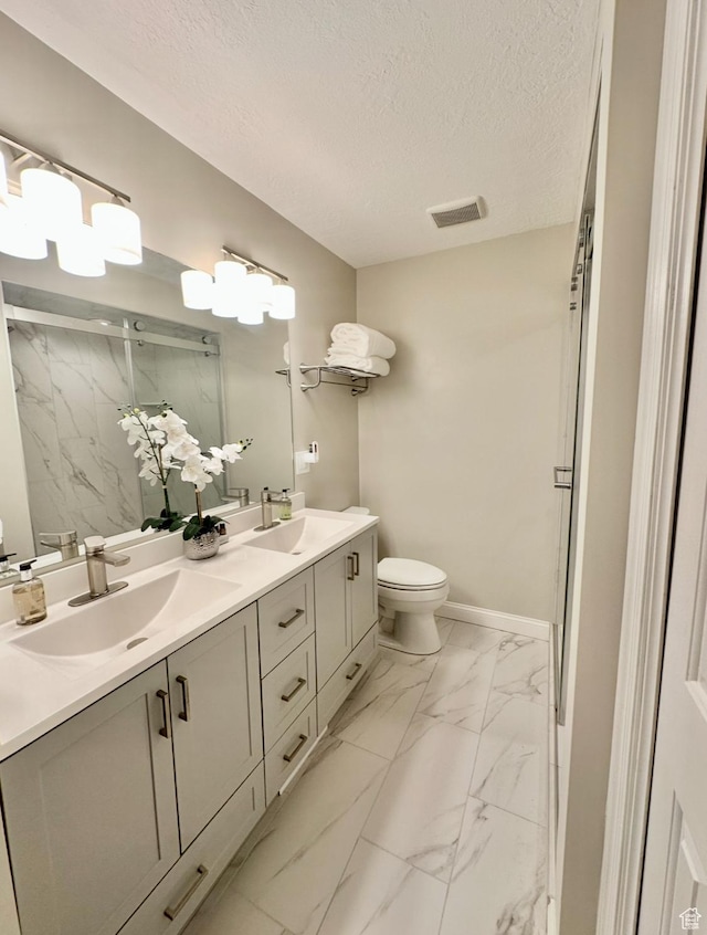 2442 N 2275 E, Layton, UT 84040 - bathroom with a marble finish shower, marble look tile flooring, double vanity, and a textured ceiling