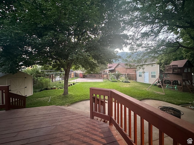 2442 N 2275 E, Layton, UT 84040 - wooden deck featuring a shed, a playground, a fire pit, and a fenced backyard