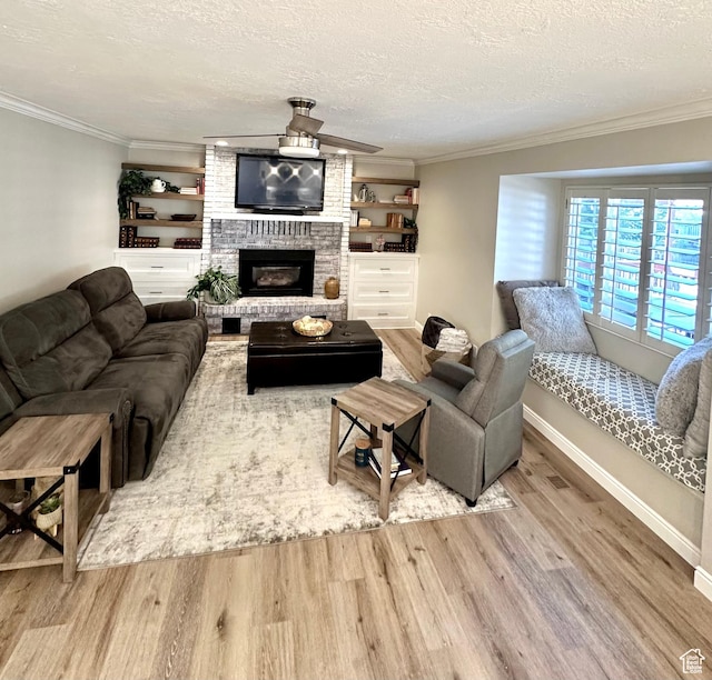 2442 N 2275 E, Layton, UT 84040 - living area with wood finished floors, crown molding, a fireplace, and a textured ceiling