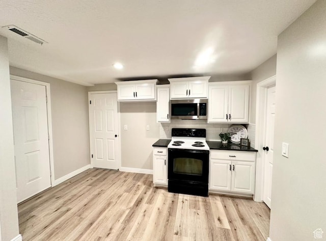 2442 N 2275 E, Layton, UT 84040 - kitchen featuring electric stove, stainless steel microwave, light wood-style floors, tasteful backsplash, and dark countertops