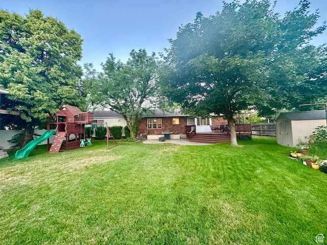 2442 N 2275 E, Layton, UT 84040 - view of yard featuring a shed, a playground, a patio, and a deck