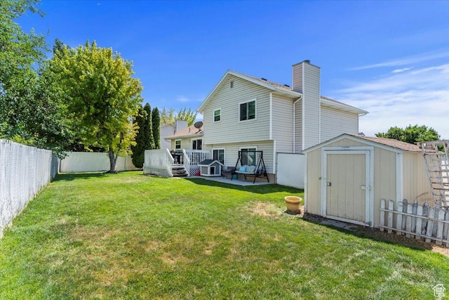 4266 S 2900 W, Roy, UT 84067 - rear view of house featuring a storage shed, a fenced backyard, a wooden deck, and a chimney