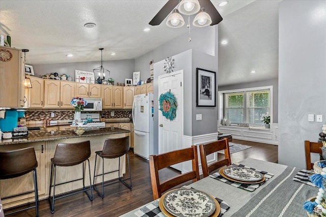 4266 S 2900 W, Roy, UT 84067 - kitchen with white appliances, lofted ceiling, a peninsula, decorative backsplash, and light brown cabinets